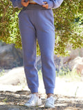 Woman wearing relaxed periwinkle blue-grey Rowena Triblend Fleece Joggers in a minimalist lifestyle setting