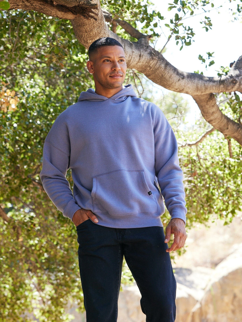 Unisex oversized triblend fleece hoodie in purple and blue-grey showing minimalist streetwear aesthetic
