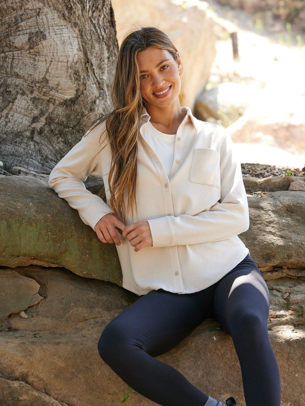 Close up of the Kandyce knit fleece button-up shirt in beige and cream colors.