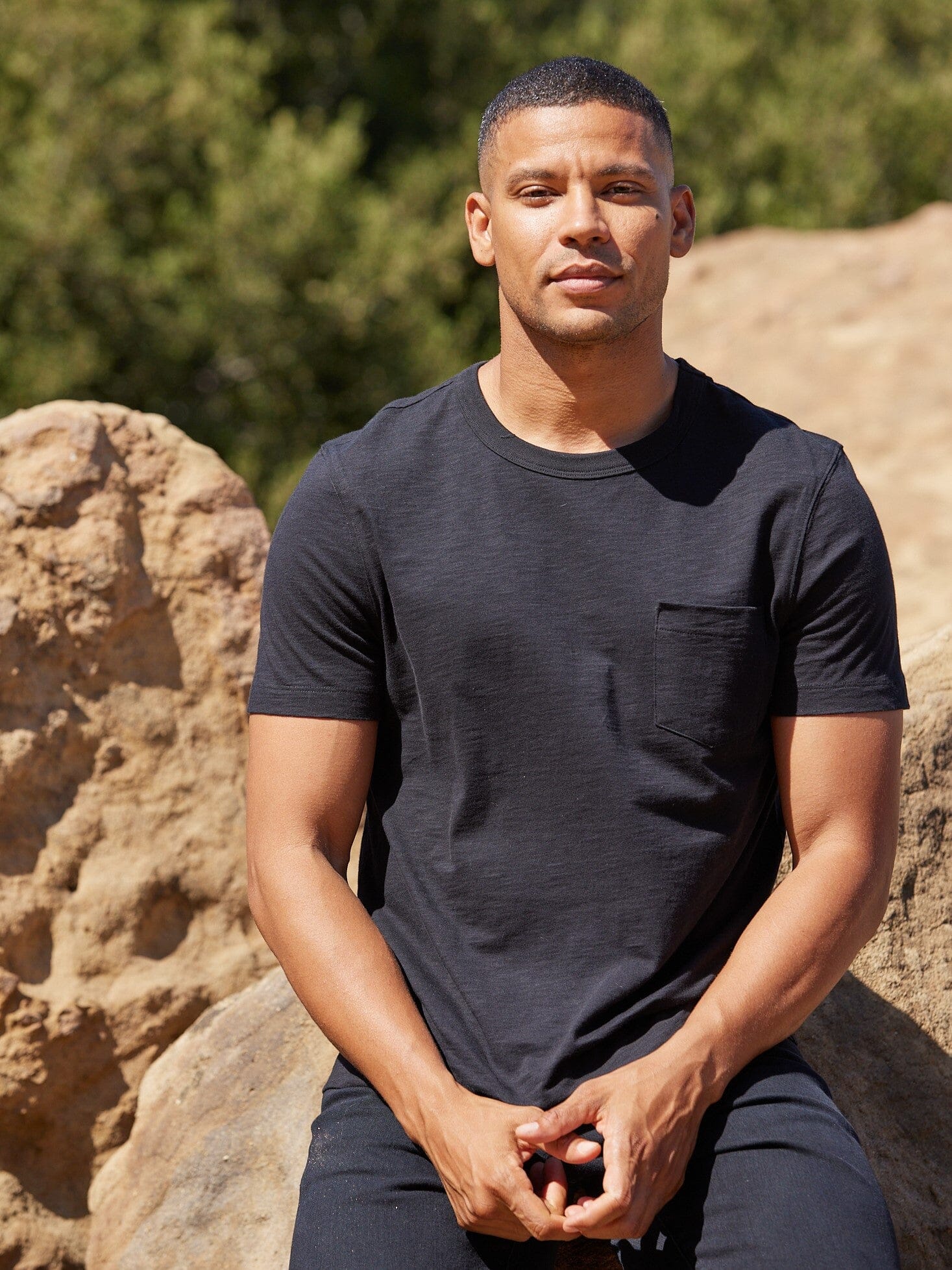 Close-up of a men's black organic cotton slub jersey pocket t-shirt.