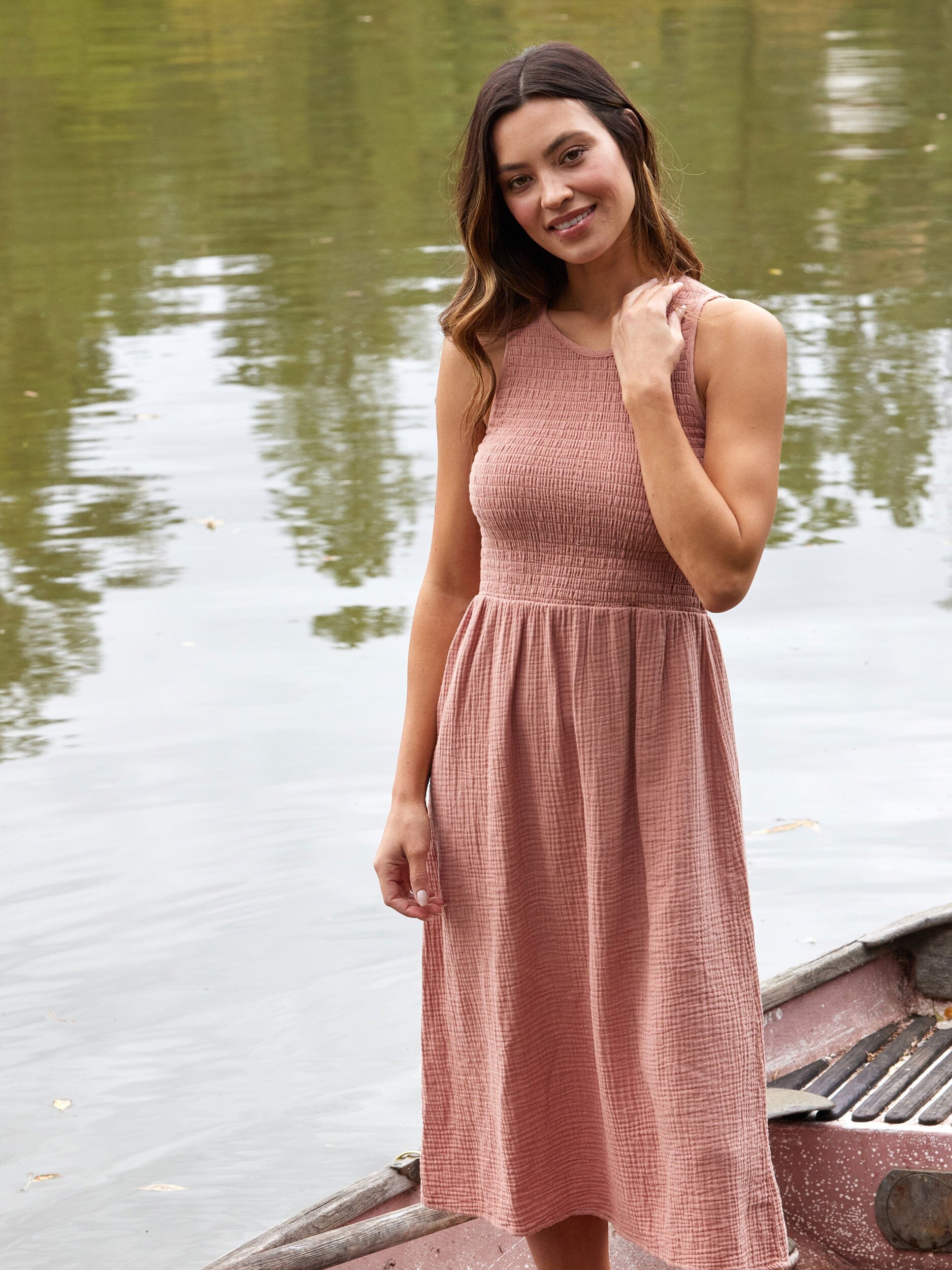 Adrienne Gauze Smocked Midi Dress in dusty rose with sleeveless design and fitted smocked bodice.