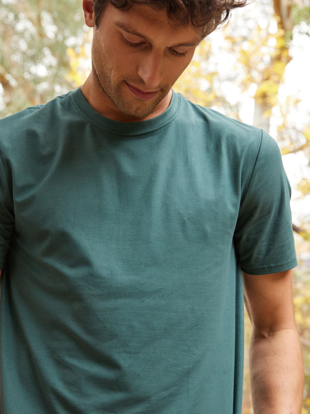 Men wearing a dark green Core Luxe Jersey crew neck tee with a minimalist design and straight fit