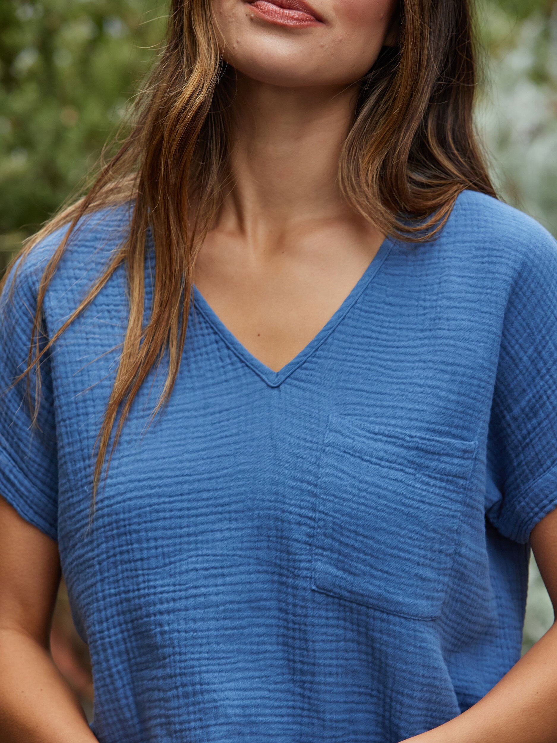 Women's Celia Gauze Top in blue with chest pocket and relaxed fit.