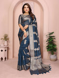 A Teal Soft Organza Silk Saree featuring intricate weaving patterns displayed on a mannequin.