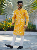 Toddler boy wearing a vibrant yellow Lucknowi silk kurta and pajama set for festive occasions