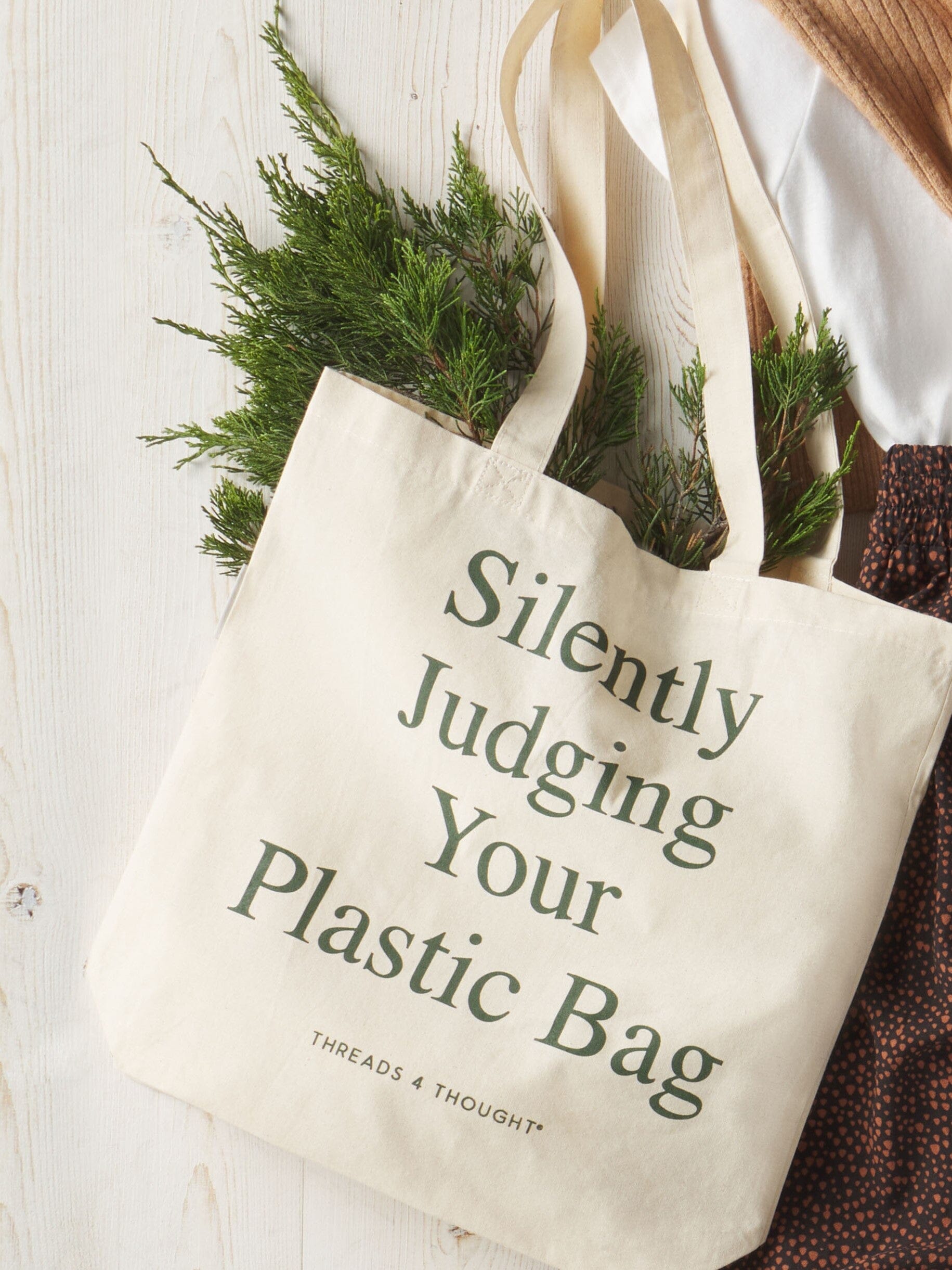 Threads 4 Thought Silently Judging Tote bag, a sustainable canvas bag supporting ocean plastic cleanup efforts.