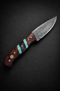 Hand-forged Damascus steel drop point utility knife with a rosewood, turquoise, and black honeycomb handle