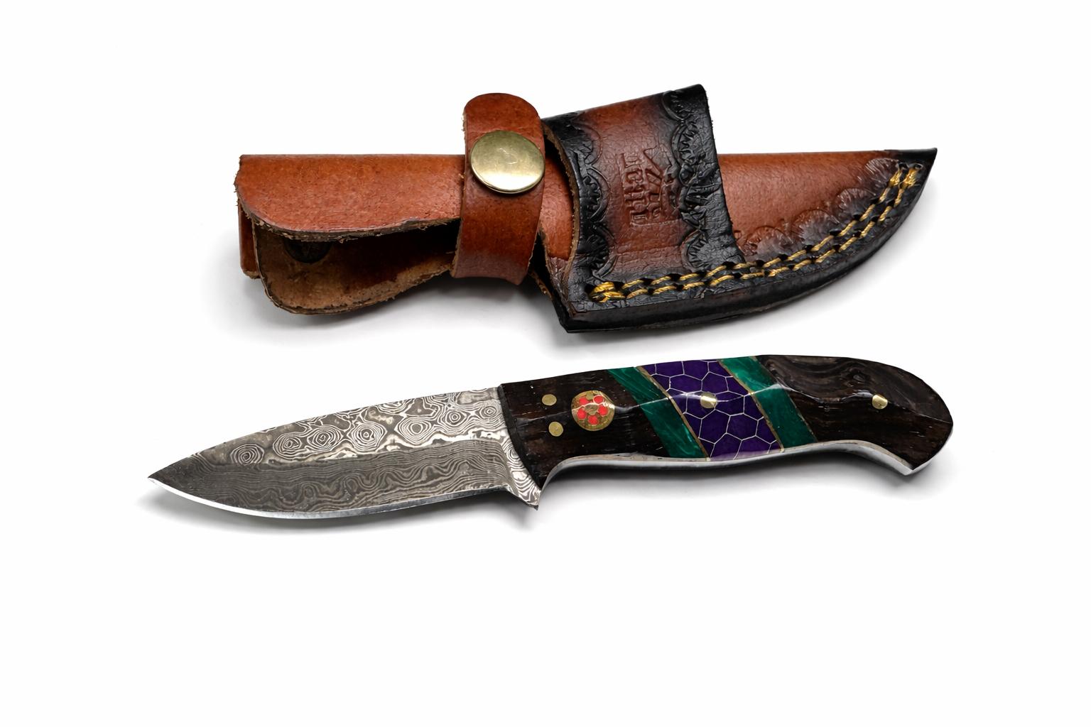 Hand-forged Damascus steel drop point utility knife with dark wood, green resin, and purple honeycomb handle