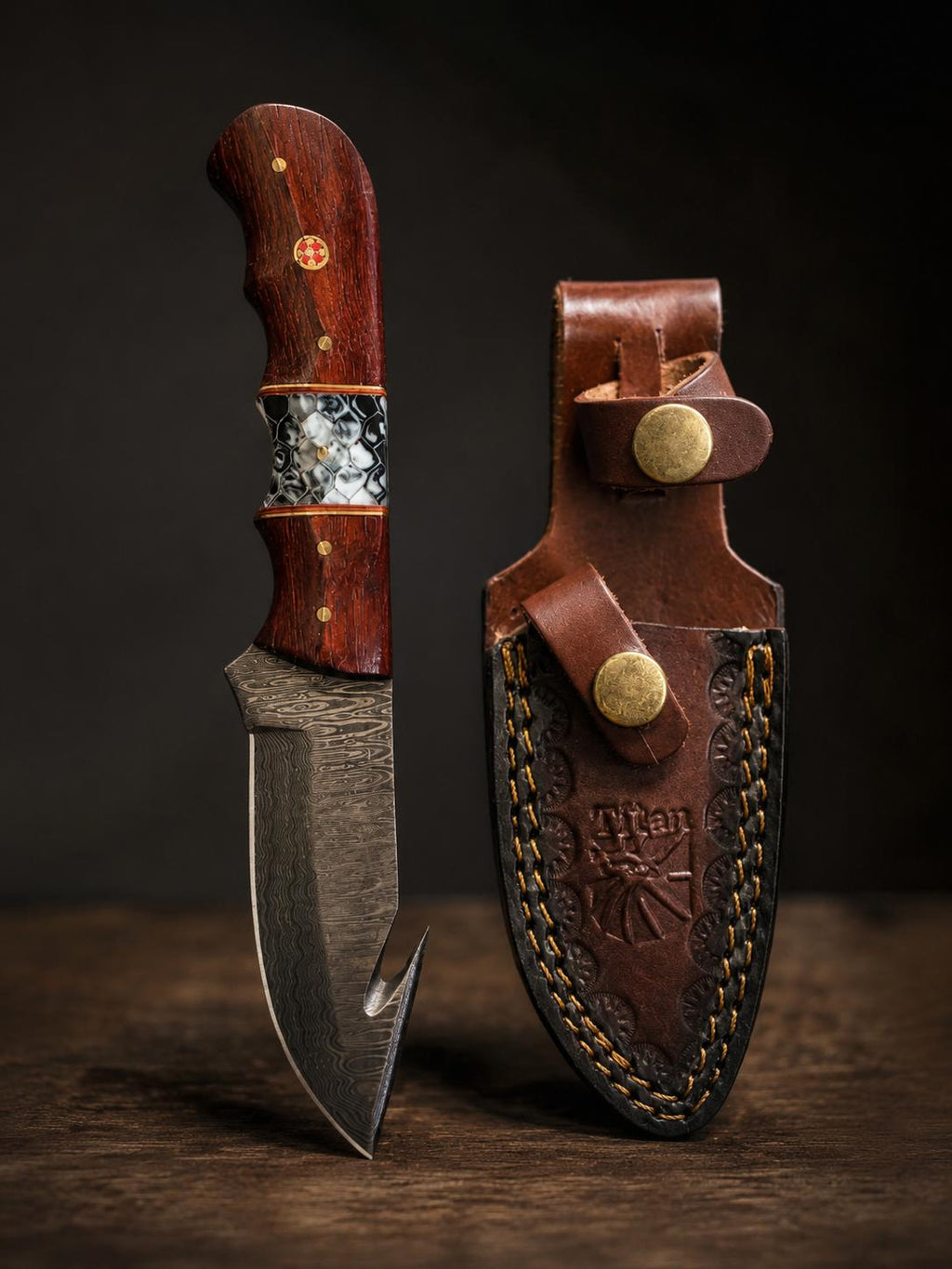 Damascus steel hunting knife with a Padauk wood and resin handle and a leather sheath