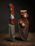 Damascus steel hunting knife with a Padauk wood and resin handle and a leather sheath