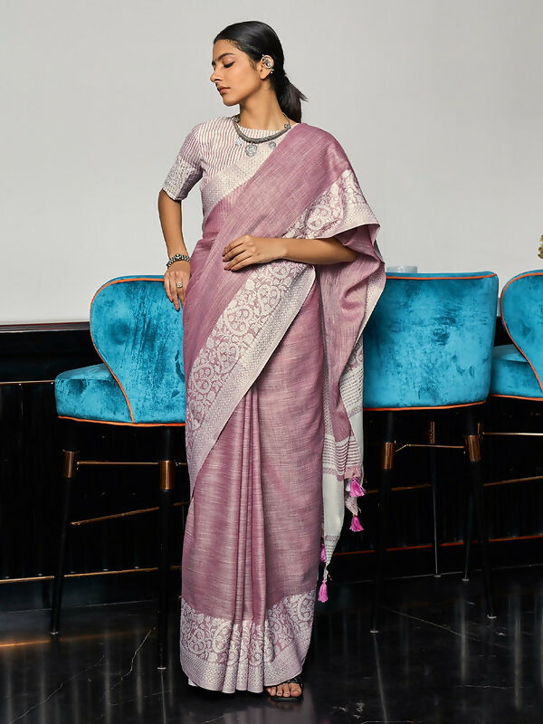 Elegant mauve woven linen saree with gold zari border and decorative pallu tassels