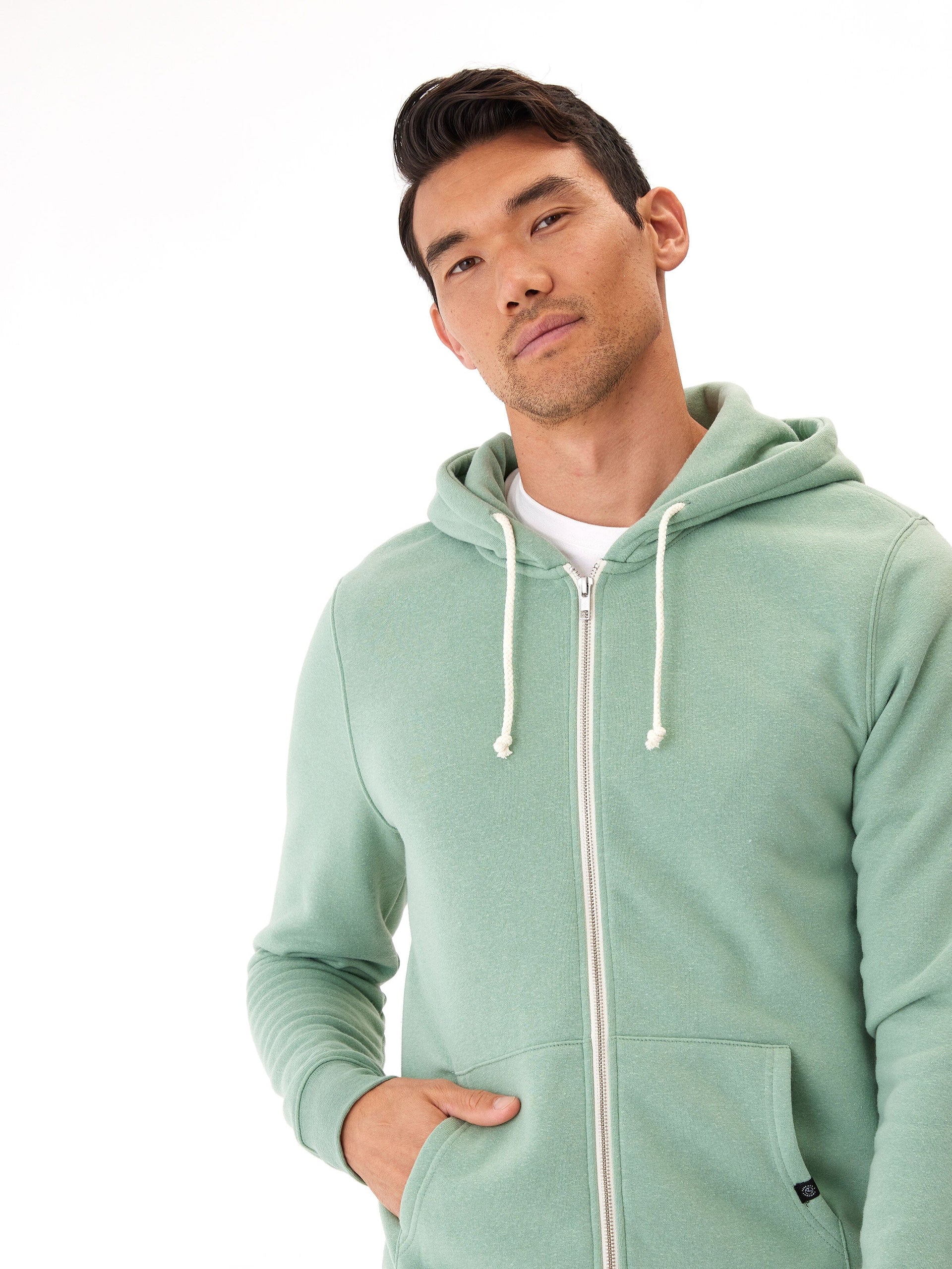 Men's Core Triblend Fleece Zip Hoodie in muted sage green with white drawstring and zipper details