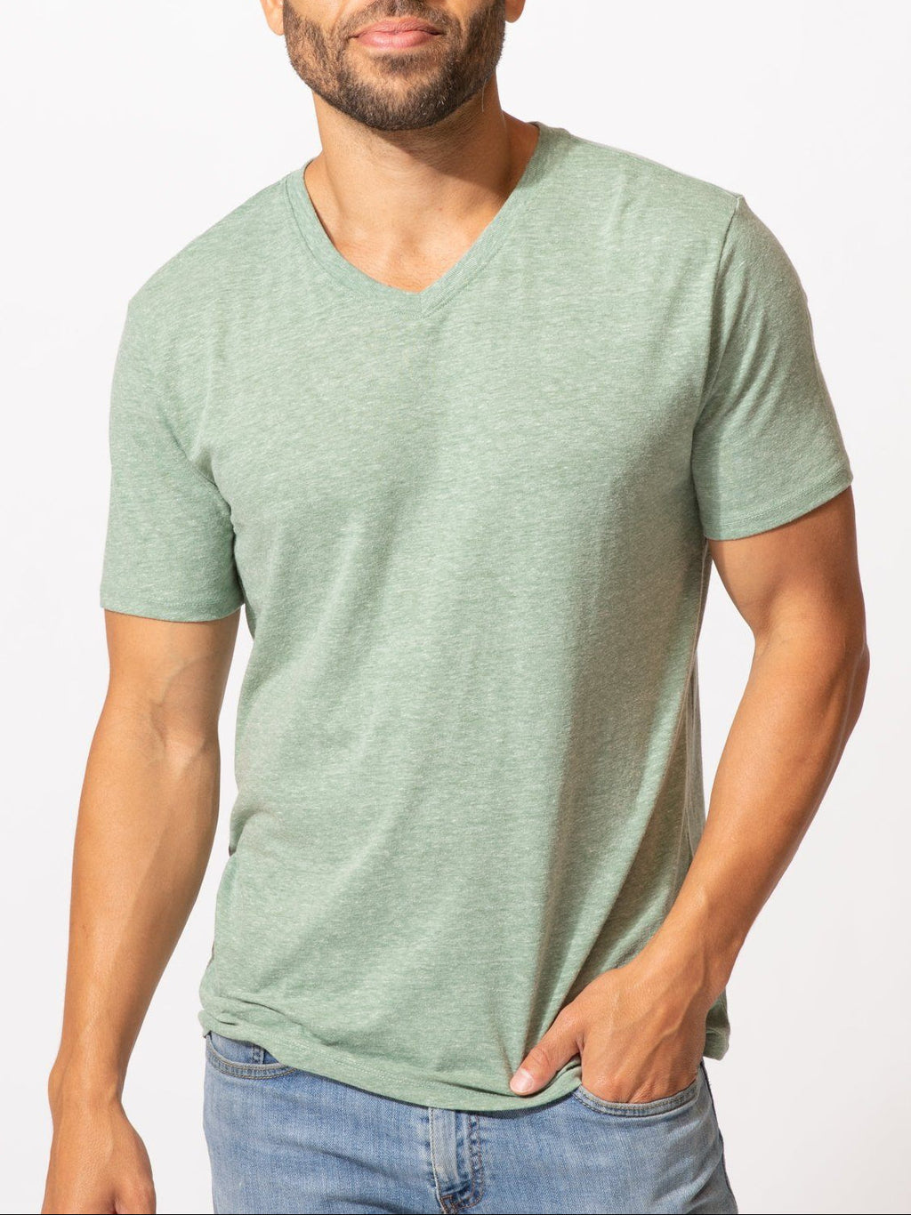 Men wearing a solid green V-neck tee made from soft triblend knit fabric, minimalist style