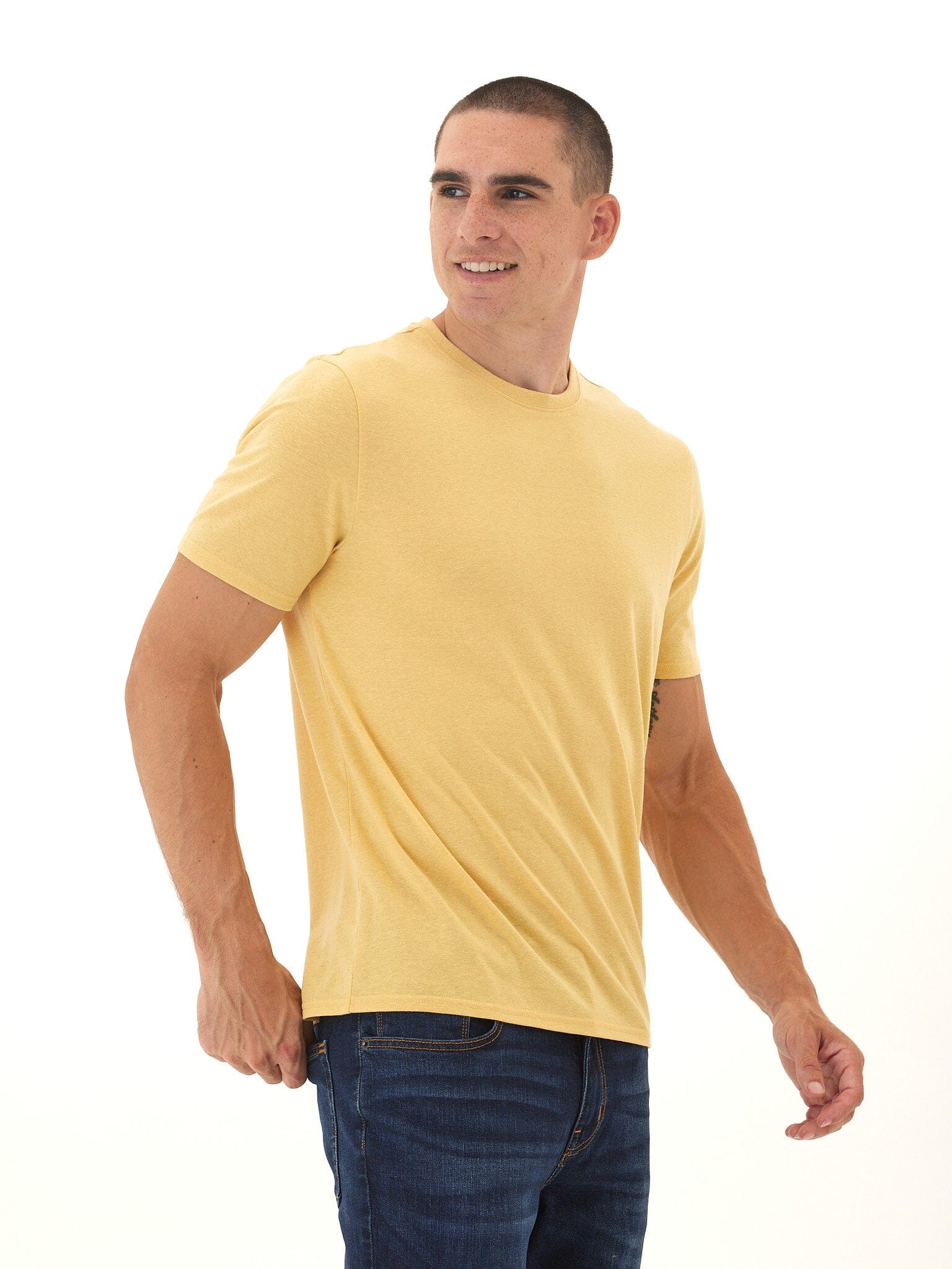 Close up of men's muted golden yellow crew neck t-shirt in a heathered knit fabric.