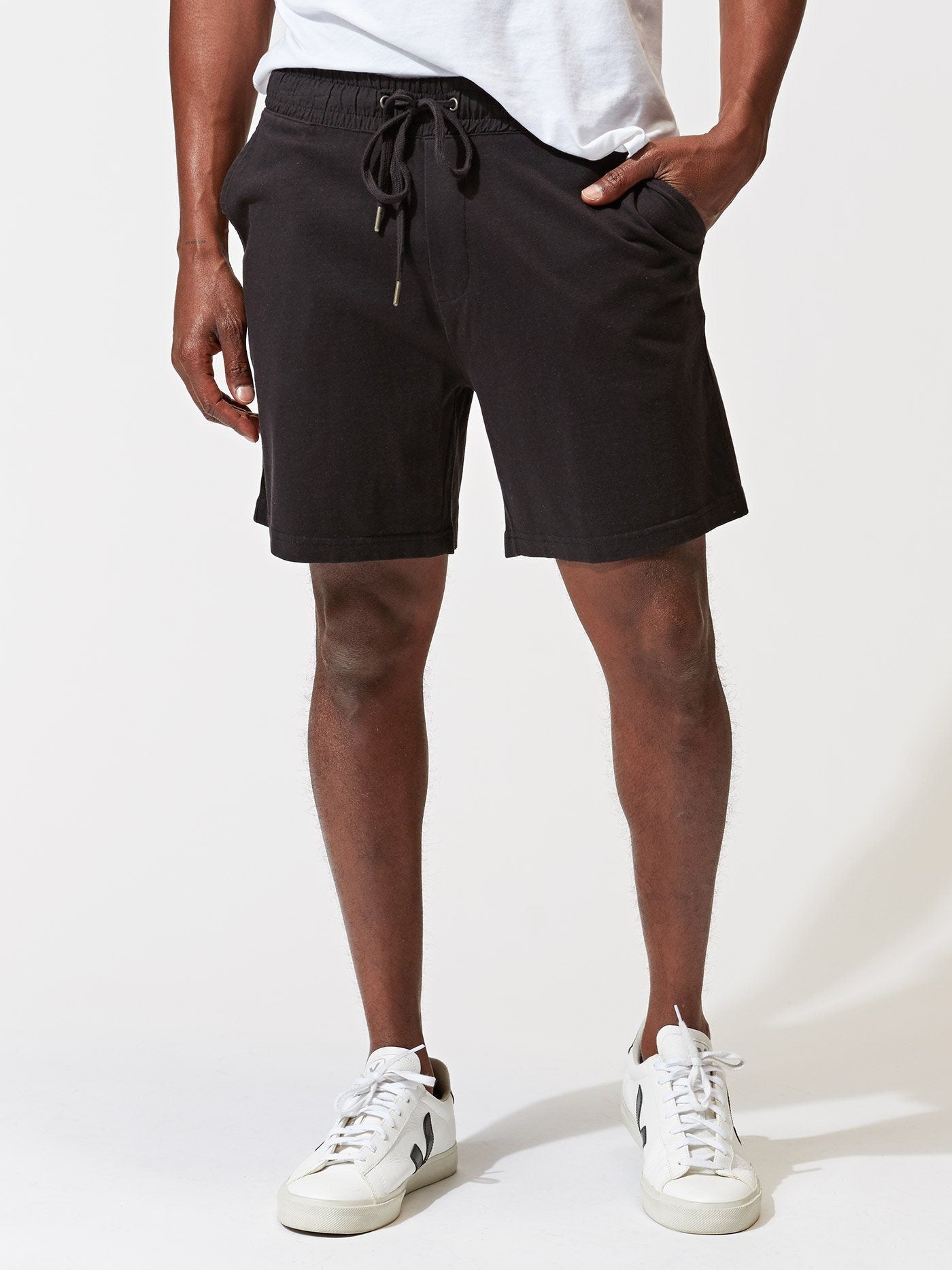 Men wearing black 6.5-inch knit athletic shorts with a solid, modern design
