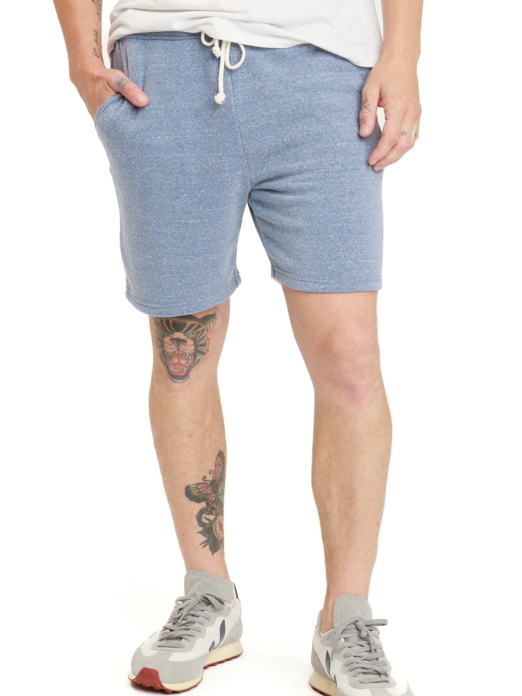 Men wearing comfortable heathered dusty blue knit fleece shorts with an adjustable drawstring waist.