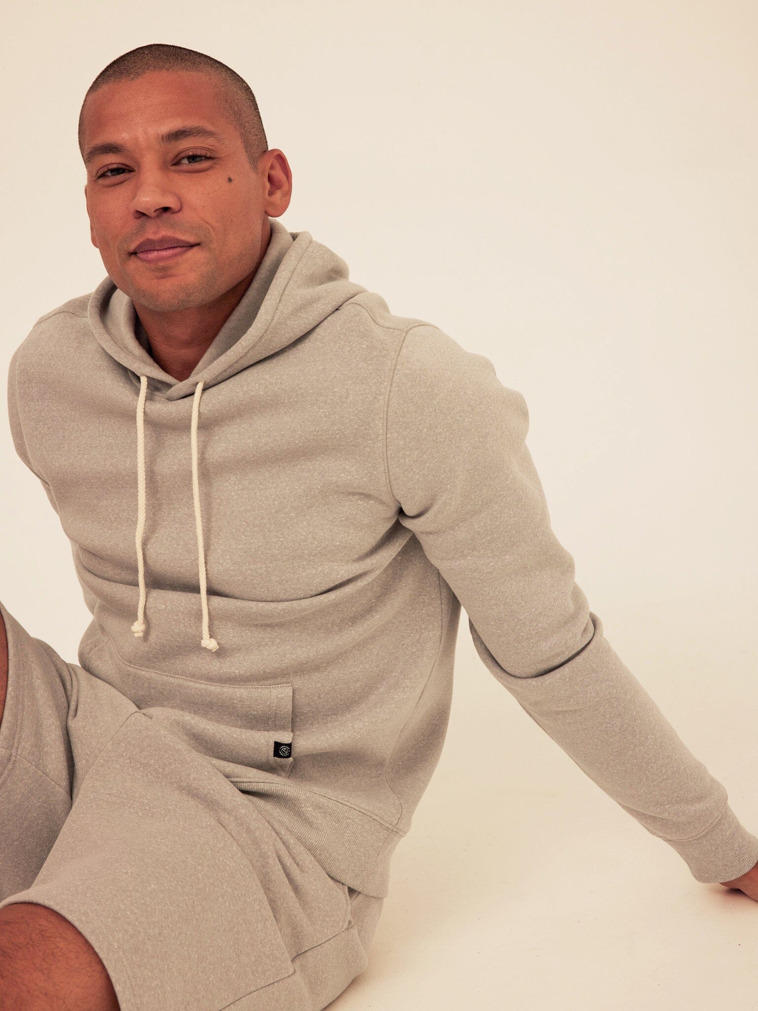 Men's light grey triblend fleece pullover hoodie with front kangaroo pocket