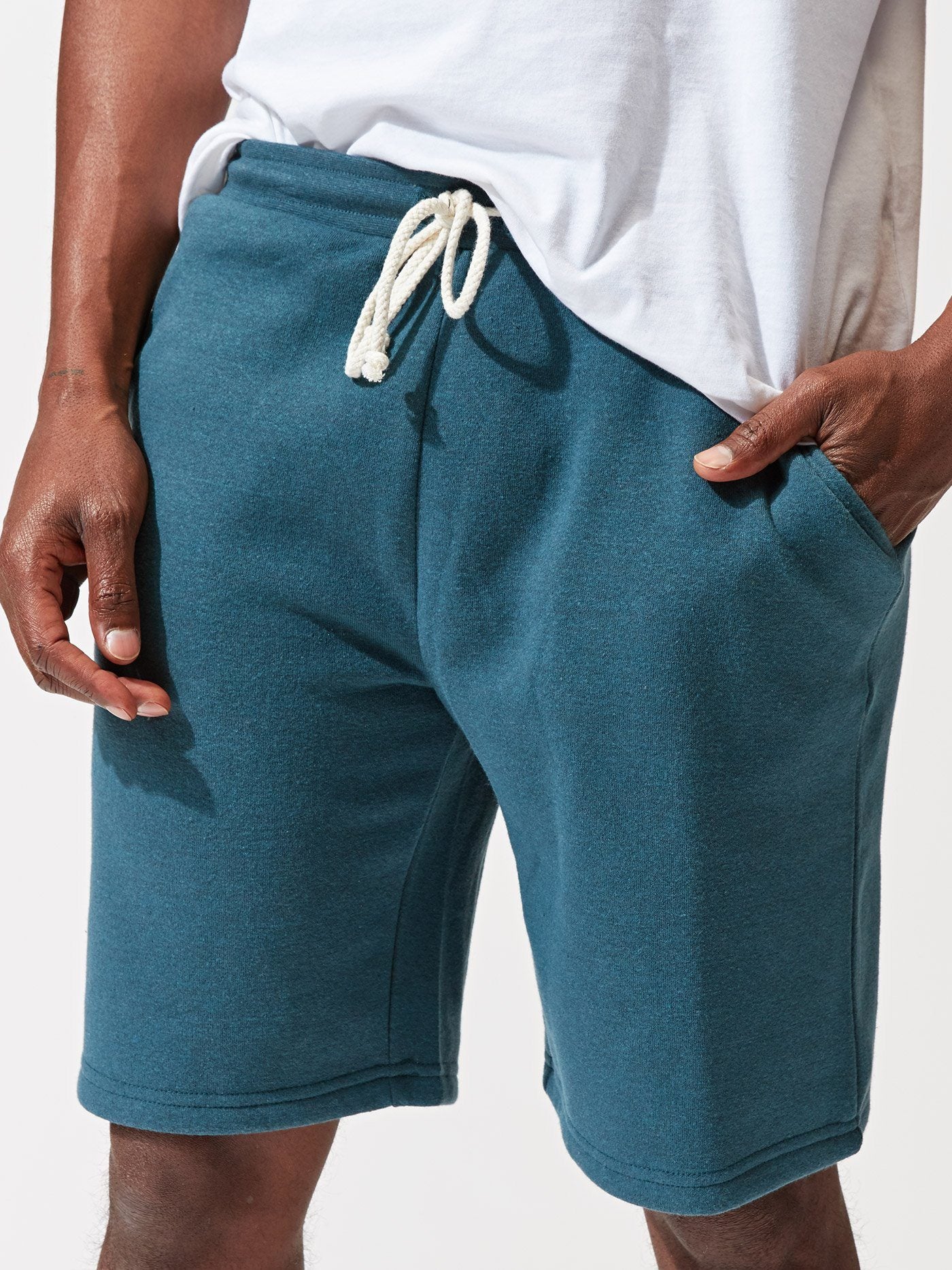 Men wearing teal Garrett 9-inch triblend knit shorts for a modern athleisure style