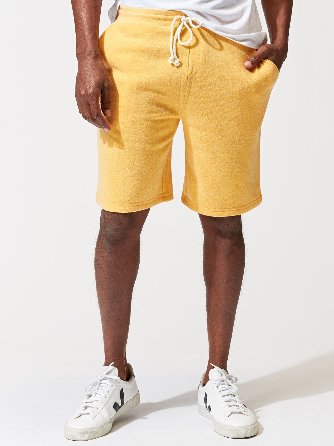 Men wearing yellow Garrett 9-inch triblend knit shorts for a casual sporty look