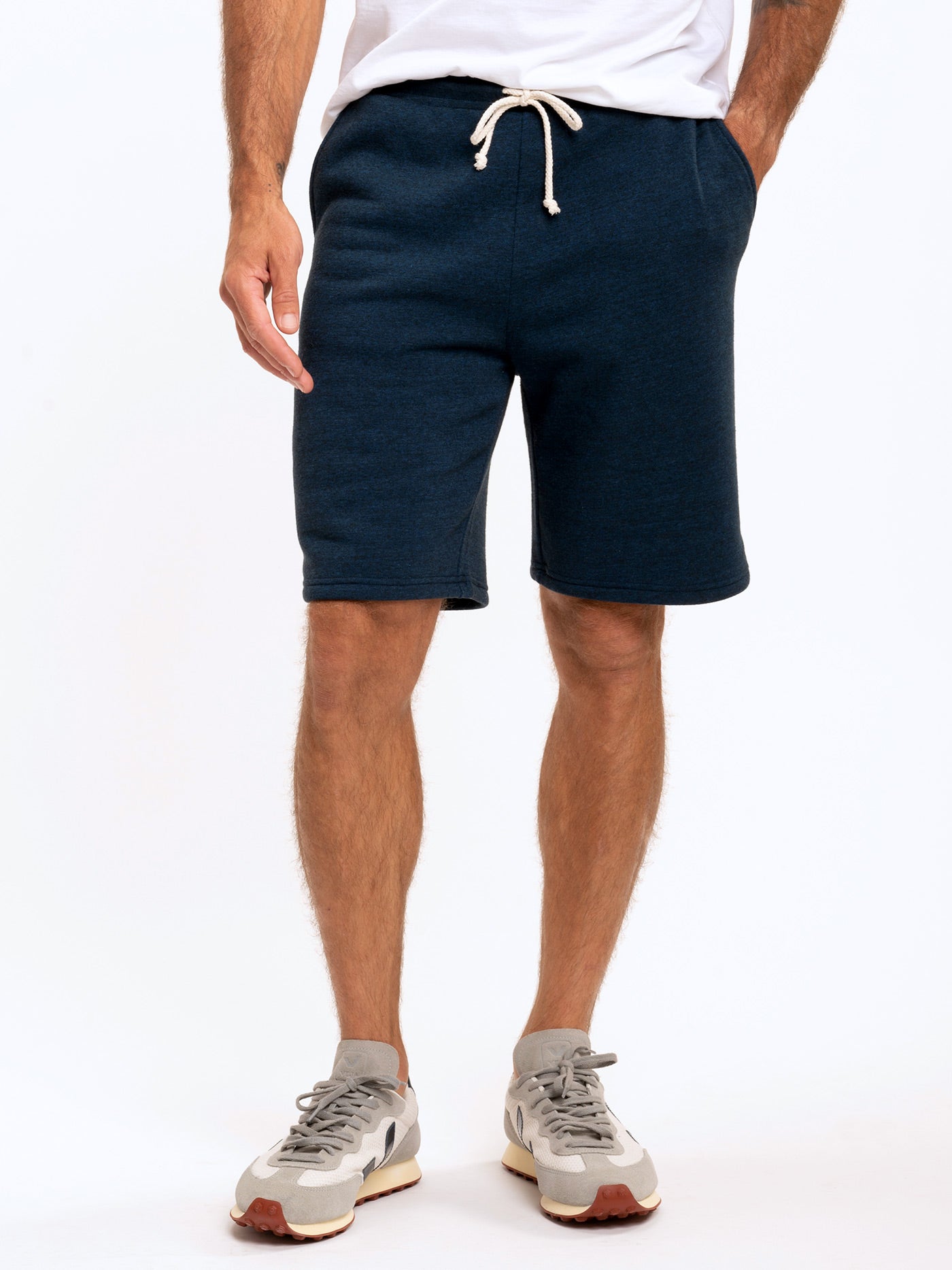Men wearing Garrett 9-inch triblend knit shorts in dark heathered navy blue
