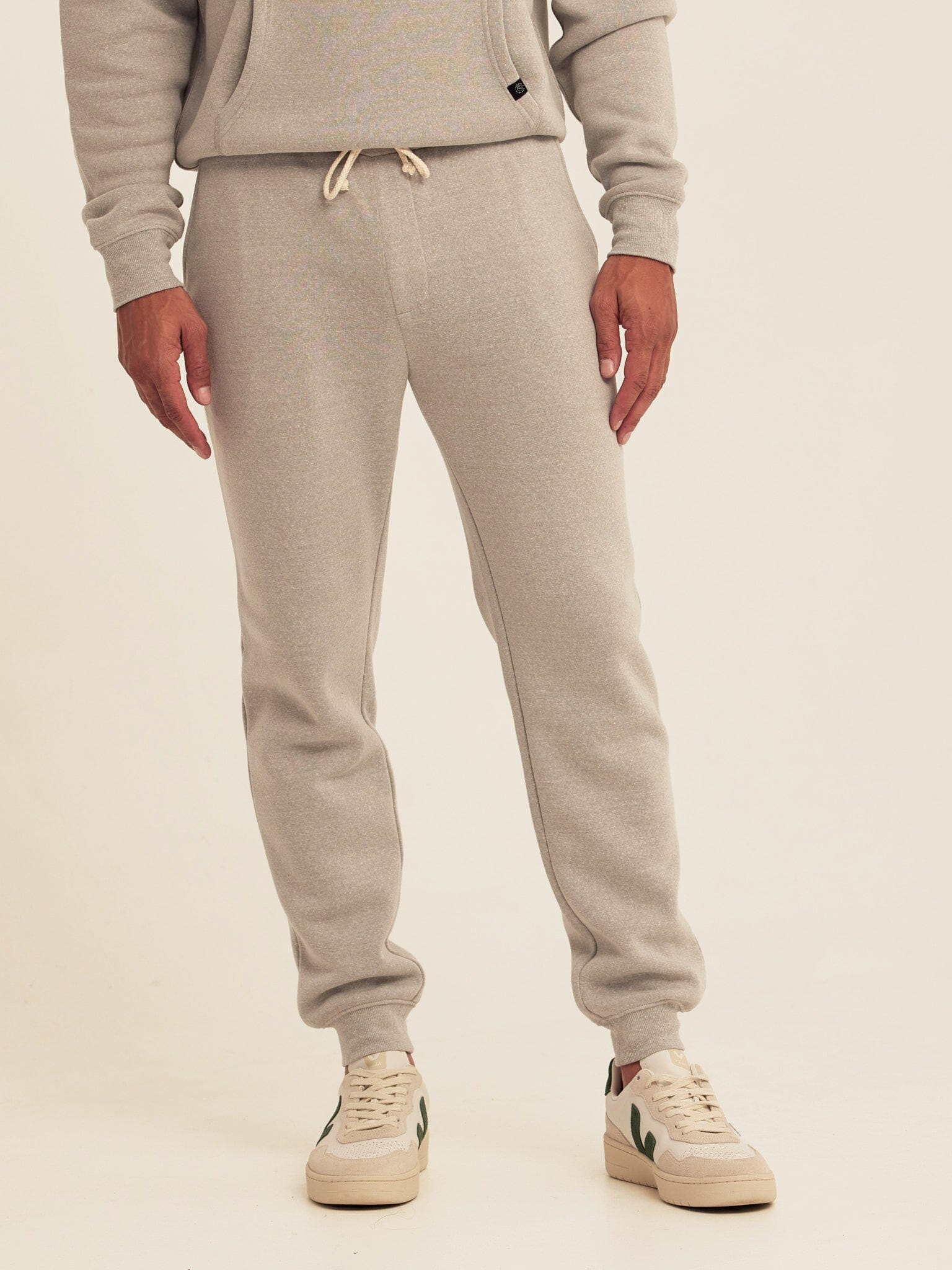 Men wearing comfortable grey straight leg triblend fleece joggers with a casual modern fit.