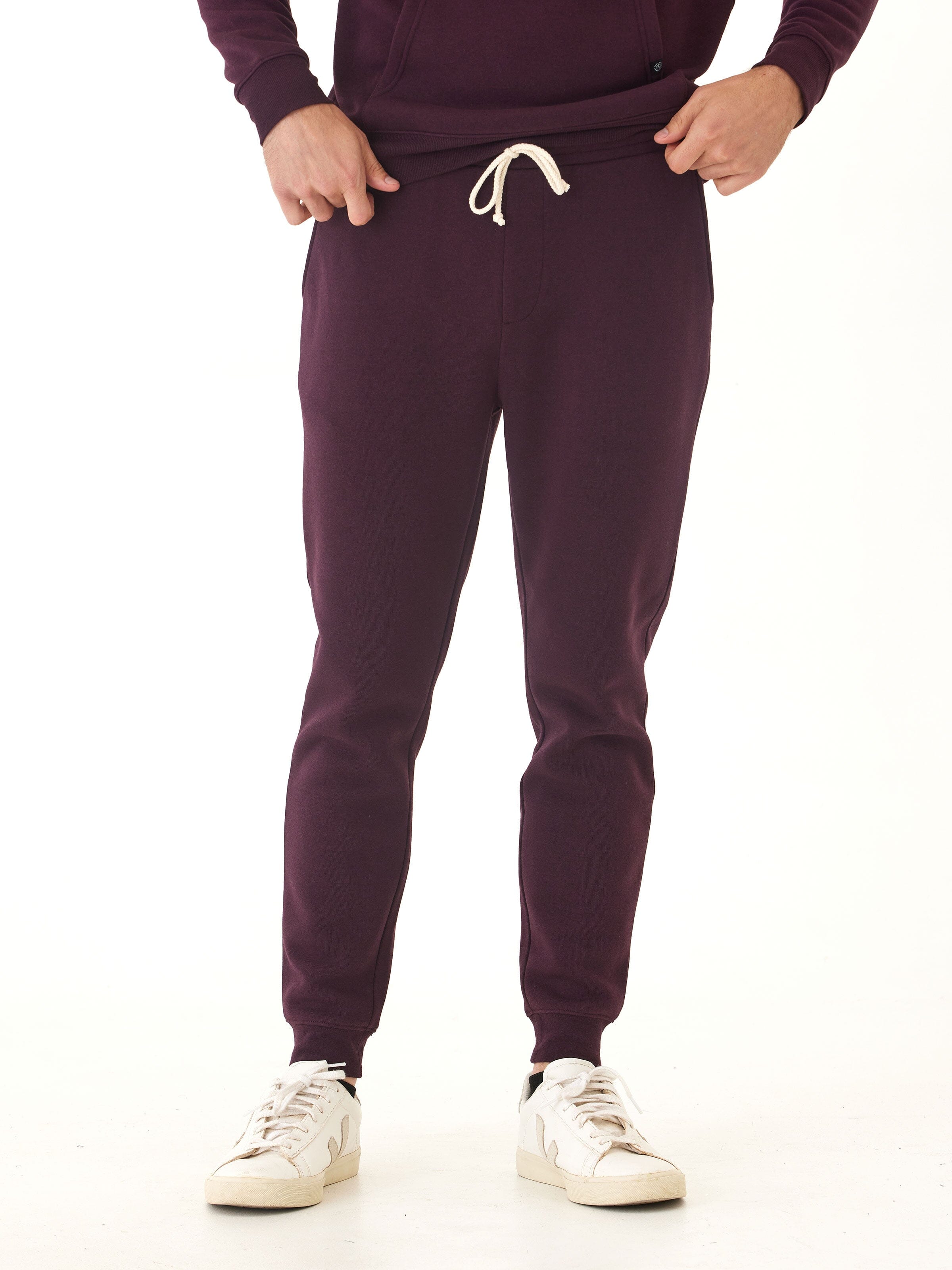 Men's slim-fit fleece joggers in deep burgundy color with a modern tapered silhouette.
