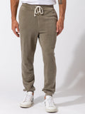 Men wearing olive green mineral wash knit fleece joggers in a casual athleisure setting