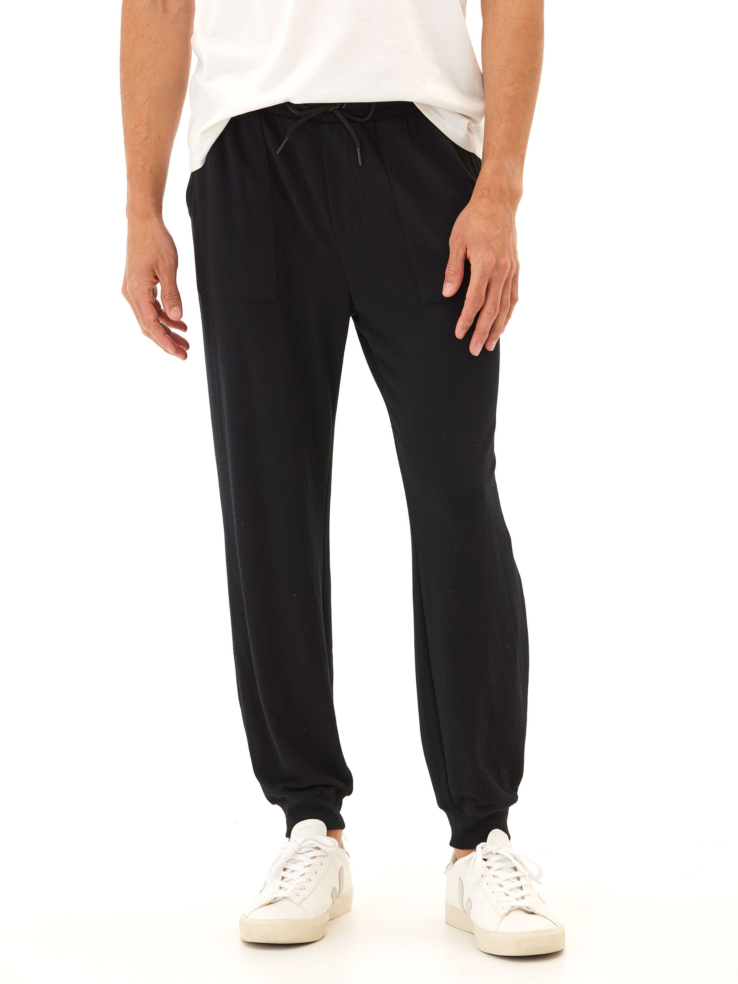 A pair of minimalist black men's French Terry knit joggers in a solid color.
