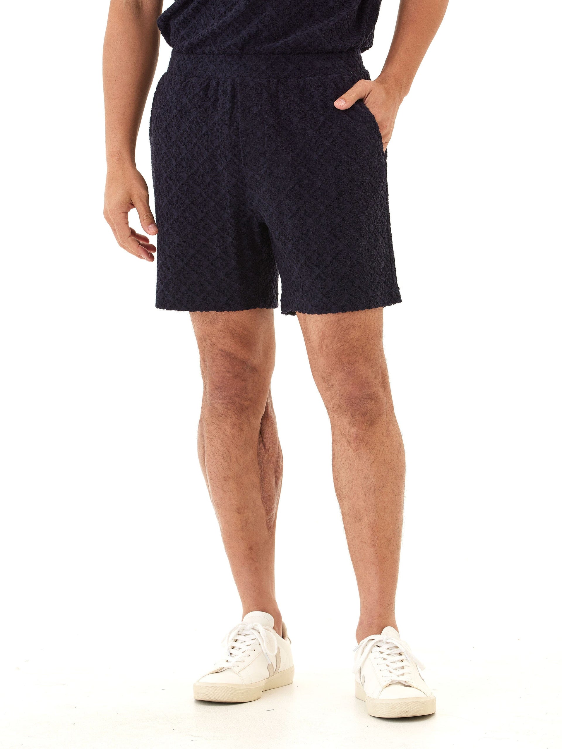 Men's navy jacquard terry shorts featuring a subtle geometric diamond pattern.