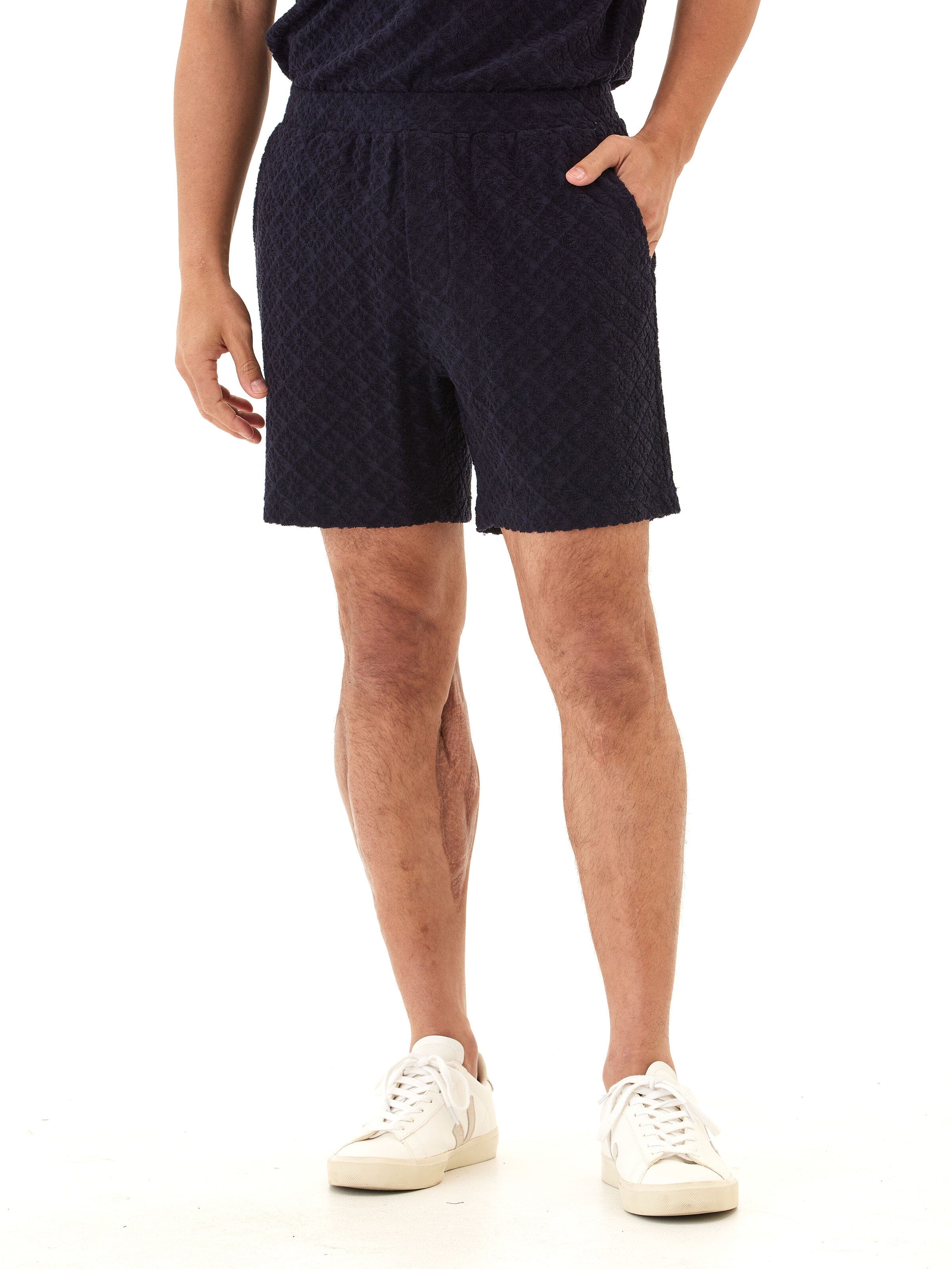 Men's navy jacquard terry shorts featuring a subtle geometric diamond pattern.