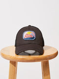 Black Cancel Plastic trucker hat with recycled mesh back and embroidered surf-culture logo.
