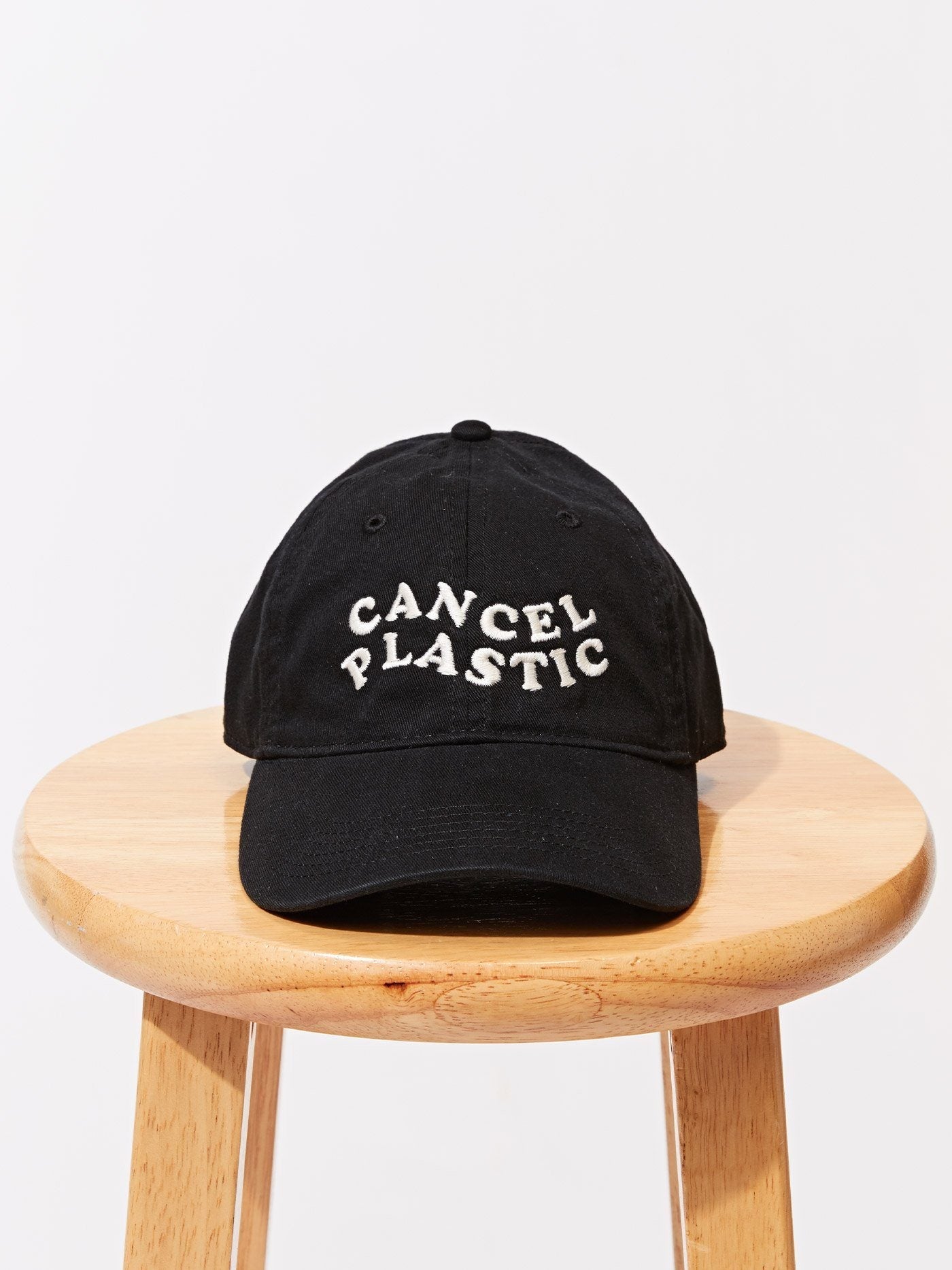 Unisex black organic cotton dad hat with wave embroidery for a minimalist streetwear look.