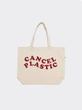 Natural beige canvas tote bag with deep red Cancel Plastic graphic text, 20x14 inches