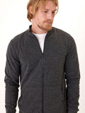 Men wearing a charcoal grey triblend fleece full zip jacket with a collared neckline and zip-fly closure.