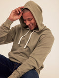 Men wearing a heavyweight mineral wash relaxed pullover hoodie in olive green