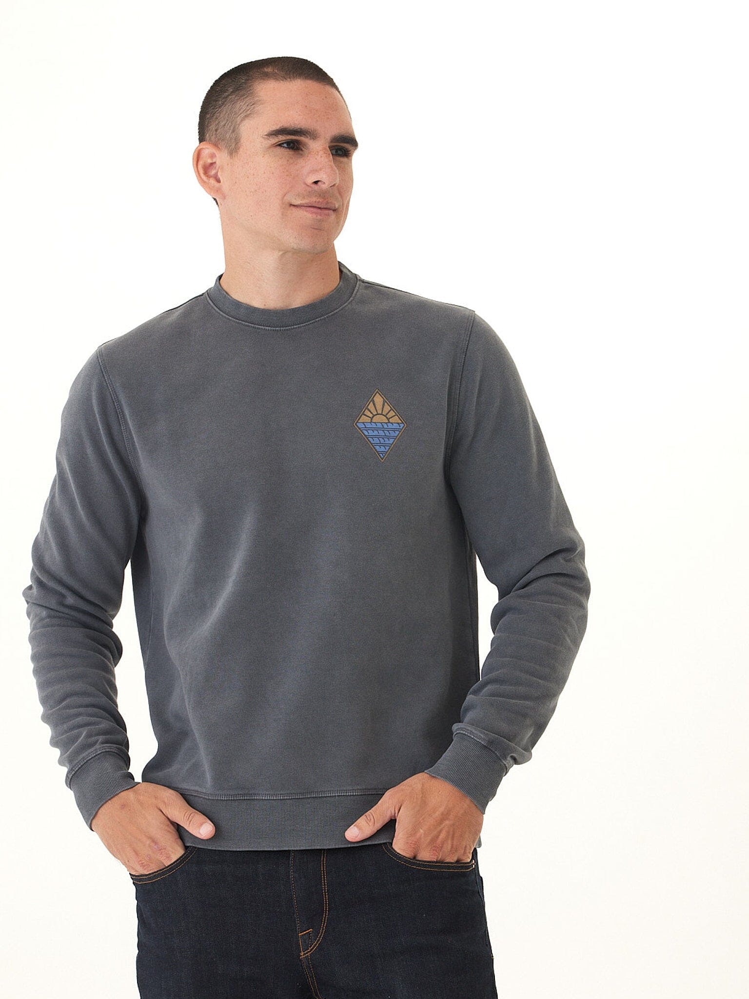 Volcom mineral wash fleece crew in charcoal grey, showing a lived-in texture and graphic artwork.