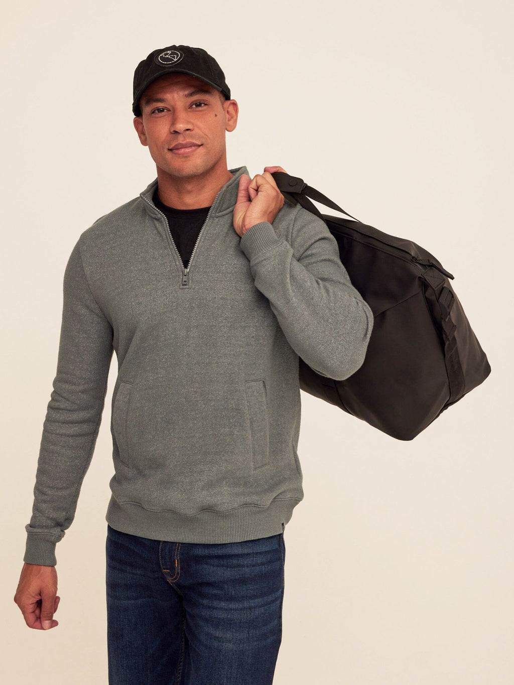 Men's grey quarter zip pullover featuring cozy fleece material, ribbed cuffs, and hem.
