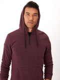 Men wearing a solid-color triblend half-zip hoodie in maroon and black