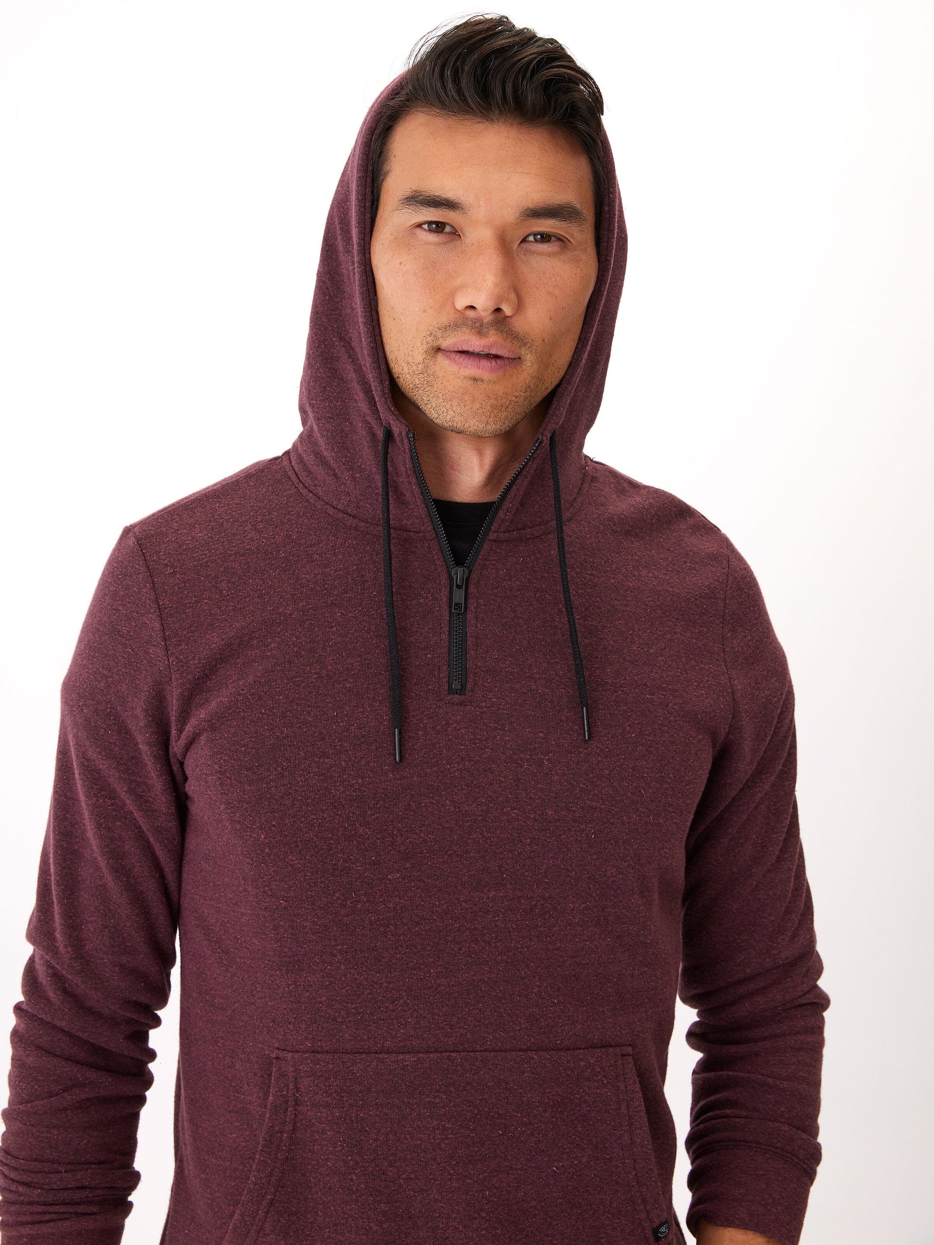 Men wearing a solid-color triblend half-zip hoodie in maroon and black