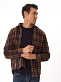 Model wearing a printed recycled fleece button-up shirt in a winter setting