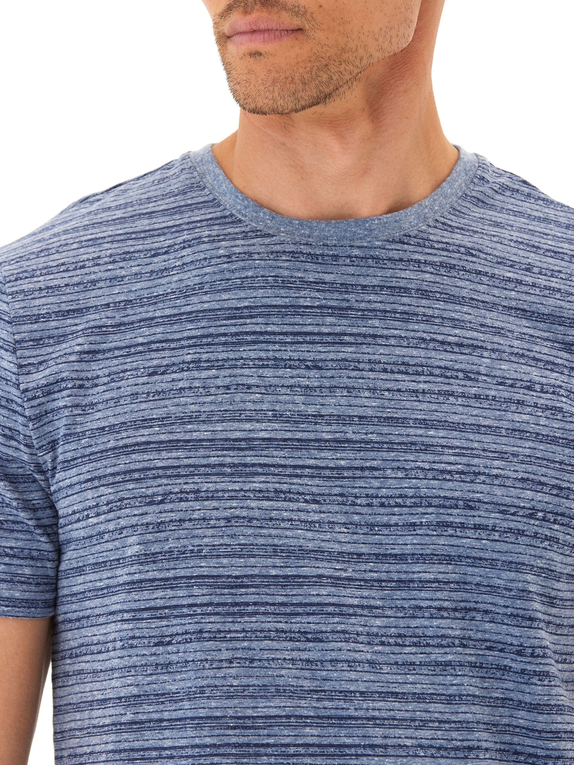 Men wearing a blue and white striped triblend jersey crew neck tee with a small hem tab logo
