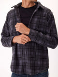 Men wearing a charcoal grey plaid fleece button-up shirt in an outdoor setting.