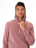 Men's solid maroon triblend fleece pullover hoodie with a small circular patch logo on the kangaroo pocket.