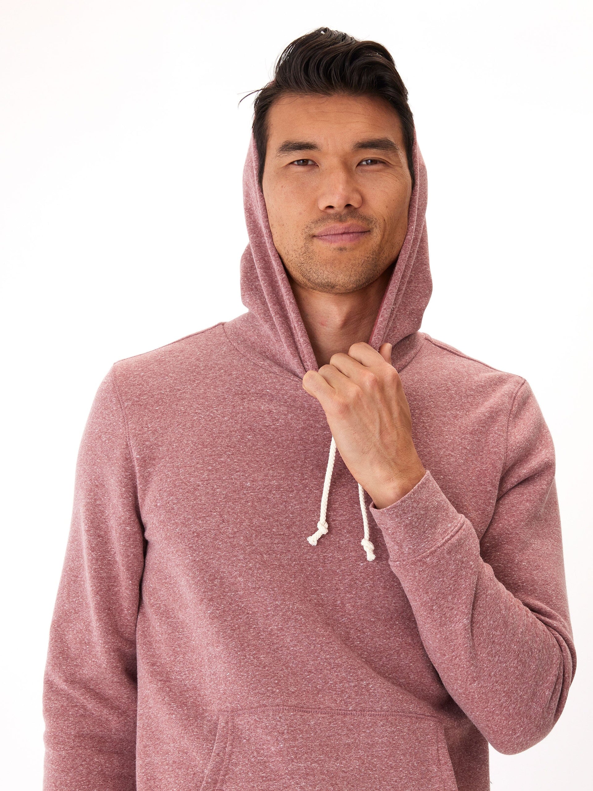 Men's solid maroon triblend fleece pullover hoodie with a small circular patch logo on the kangaroo pocket.