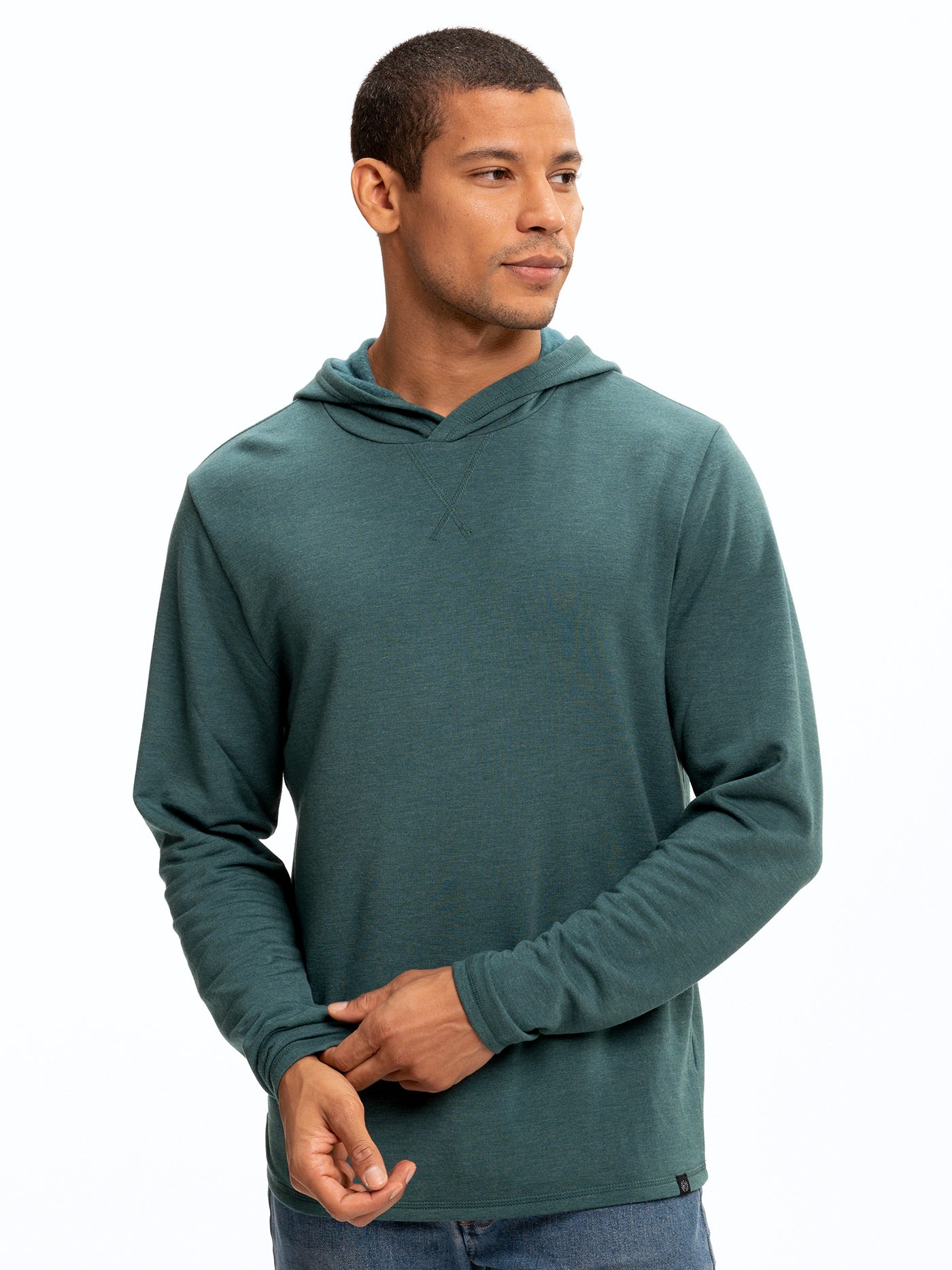 Men wearing a solid teal Core Feather Fleece hoodie with a relaxed hood and athletic fit.