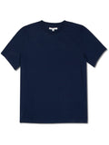 A man wearing a solid navy short sleeve crew neck t-shirt in a minimalist, casual lifestyle setting.