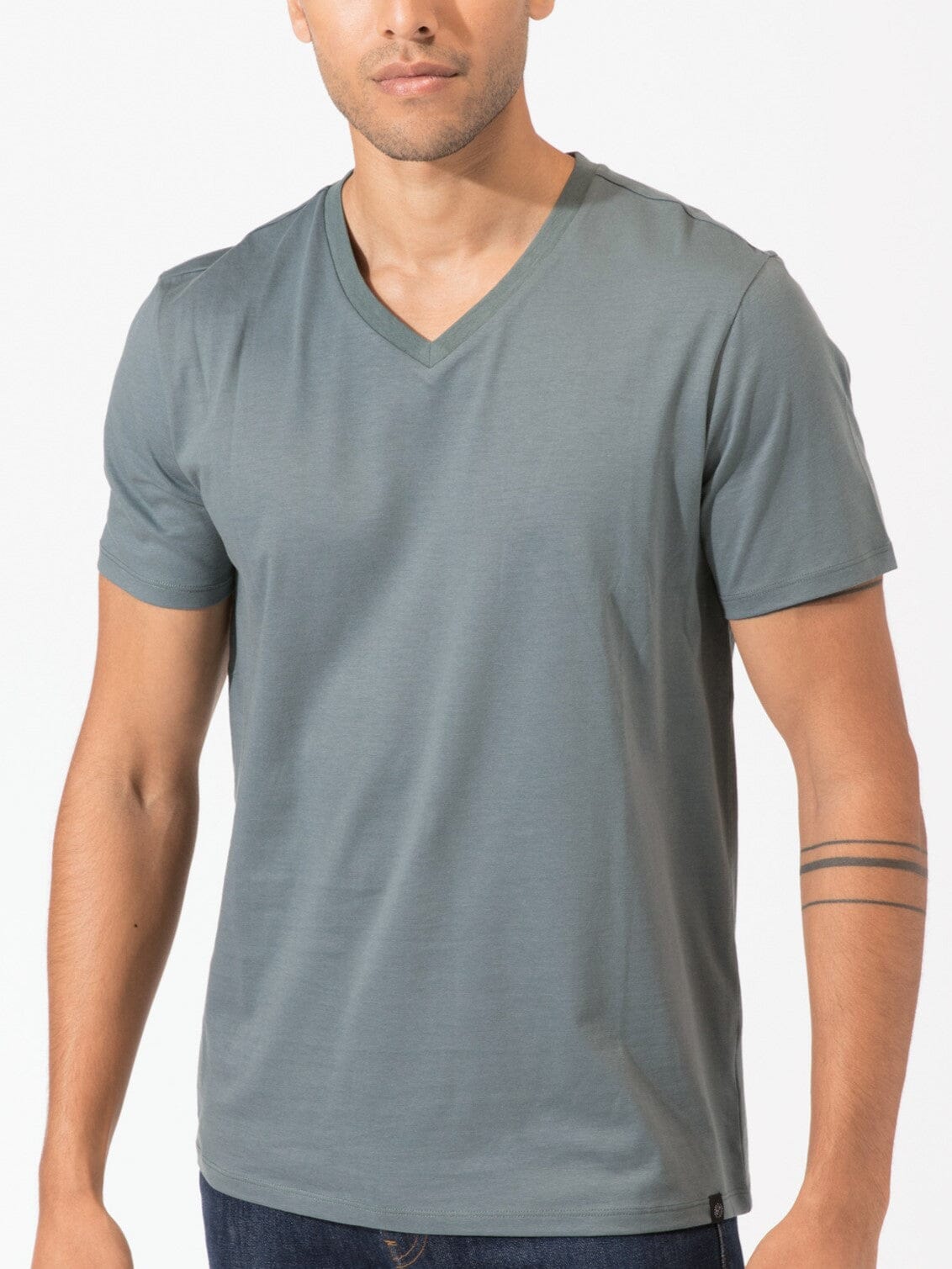 Men's Invincible V-Neck tee in slate-blue and grey, showcasing liquid-resistant organic cotton fabric