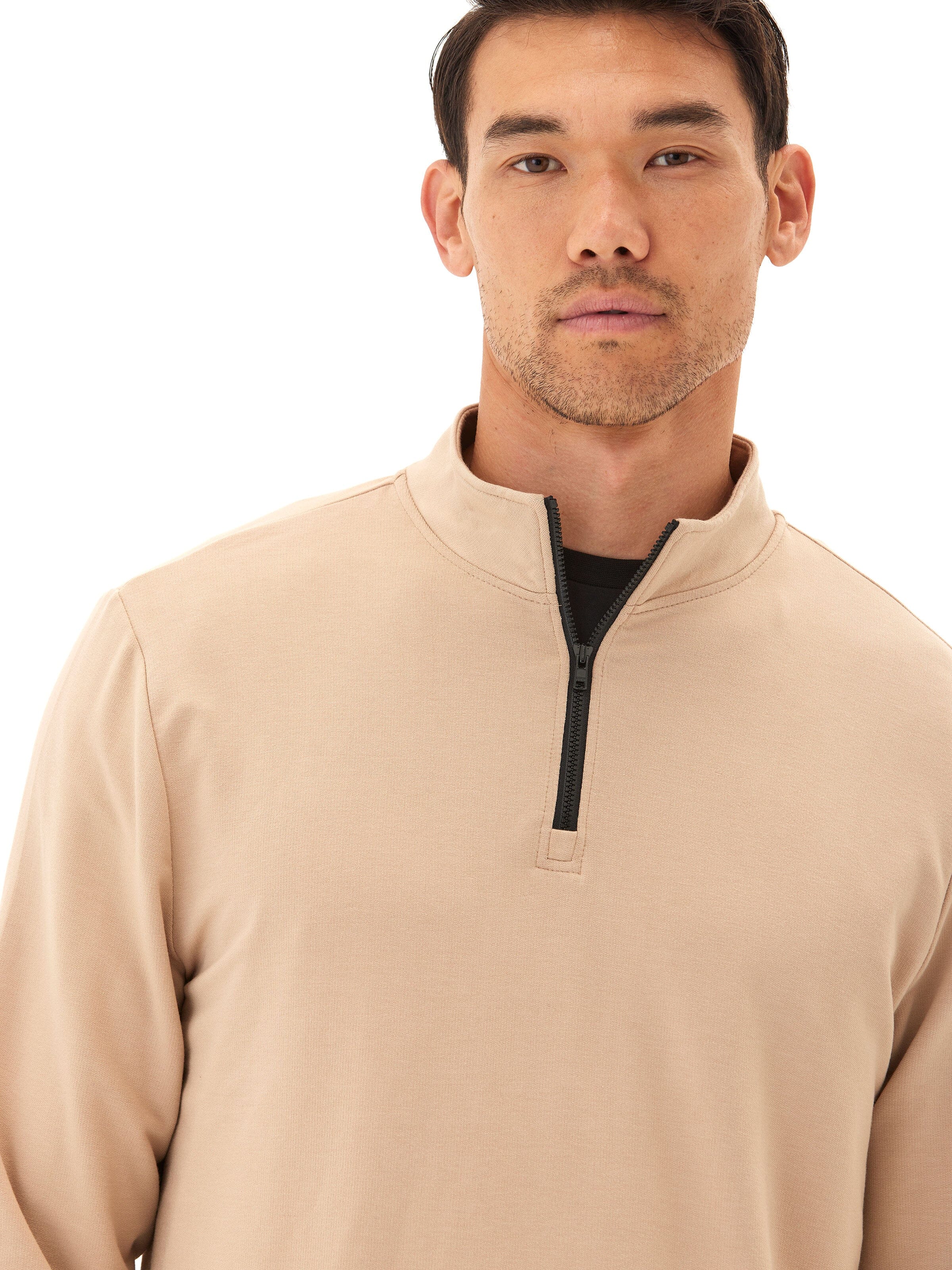 Model wearing a comfortable modal terry quarter-zip mock neck pullover in a classic fit.