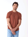 Men wearing a lightweight rust and white striped triblend jersey short sleeve henley shirt.