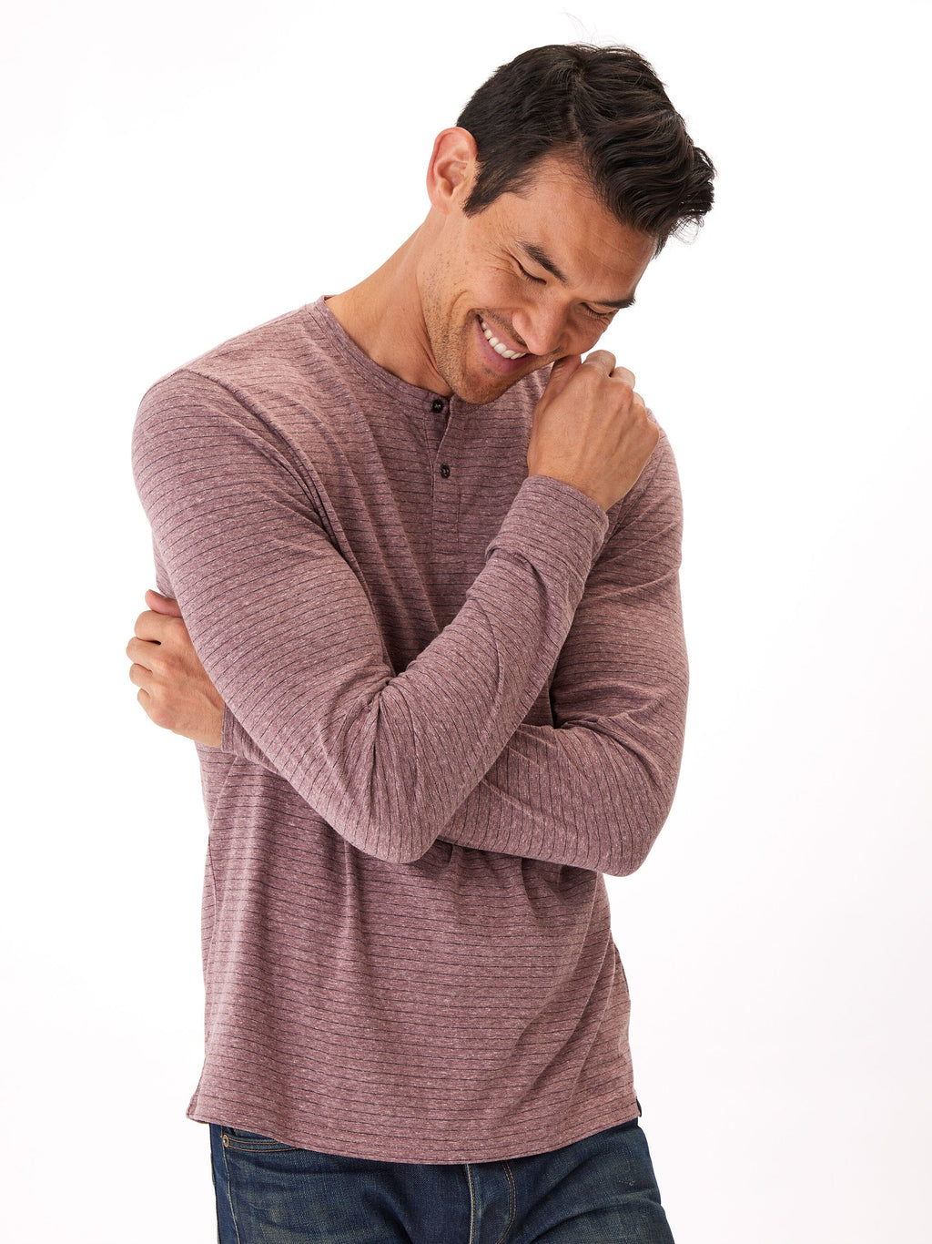Close up of a stripe pattern long sleeve henley shirt featuring a button placket